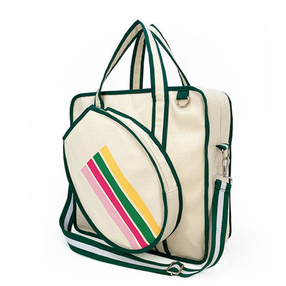 Cream canvas tote bag with green trim, detachable rainbow-striped pouch, top handles, and striped shoulder strap.