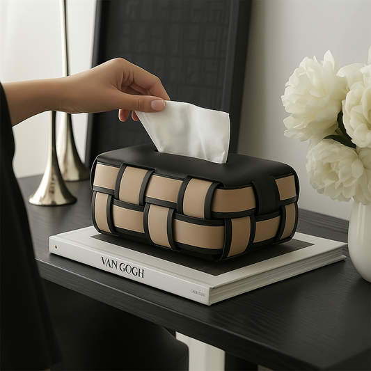 Woven leather tissue box cover in tan and black basketweave pattern on Van Gogh book with white flowers