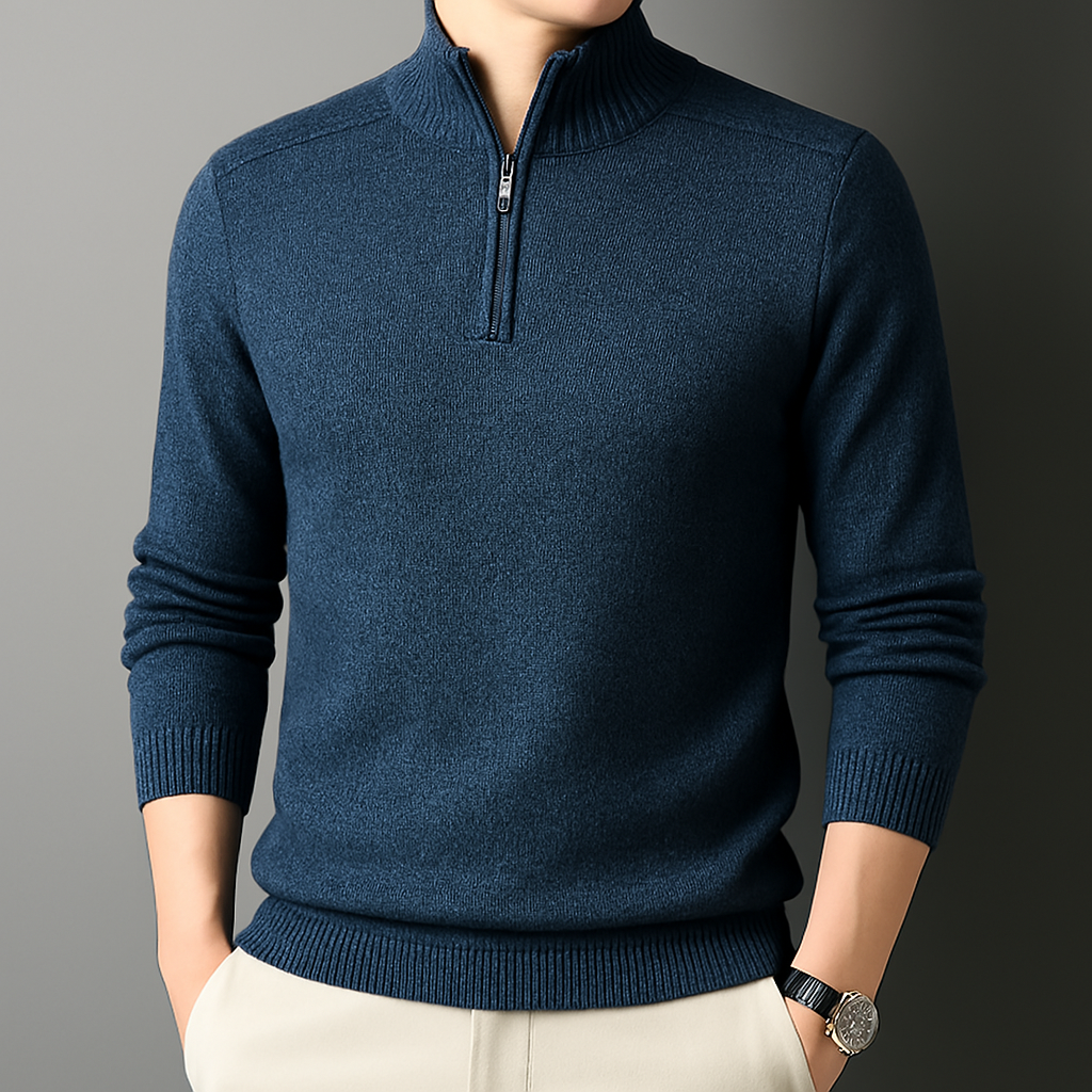 Navy blue men's wool blend quarter-zip sweater with ribbed collar, cuffs, and hem, styled with cream trousers.
