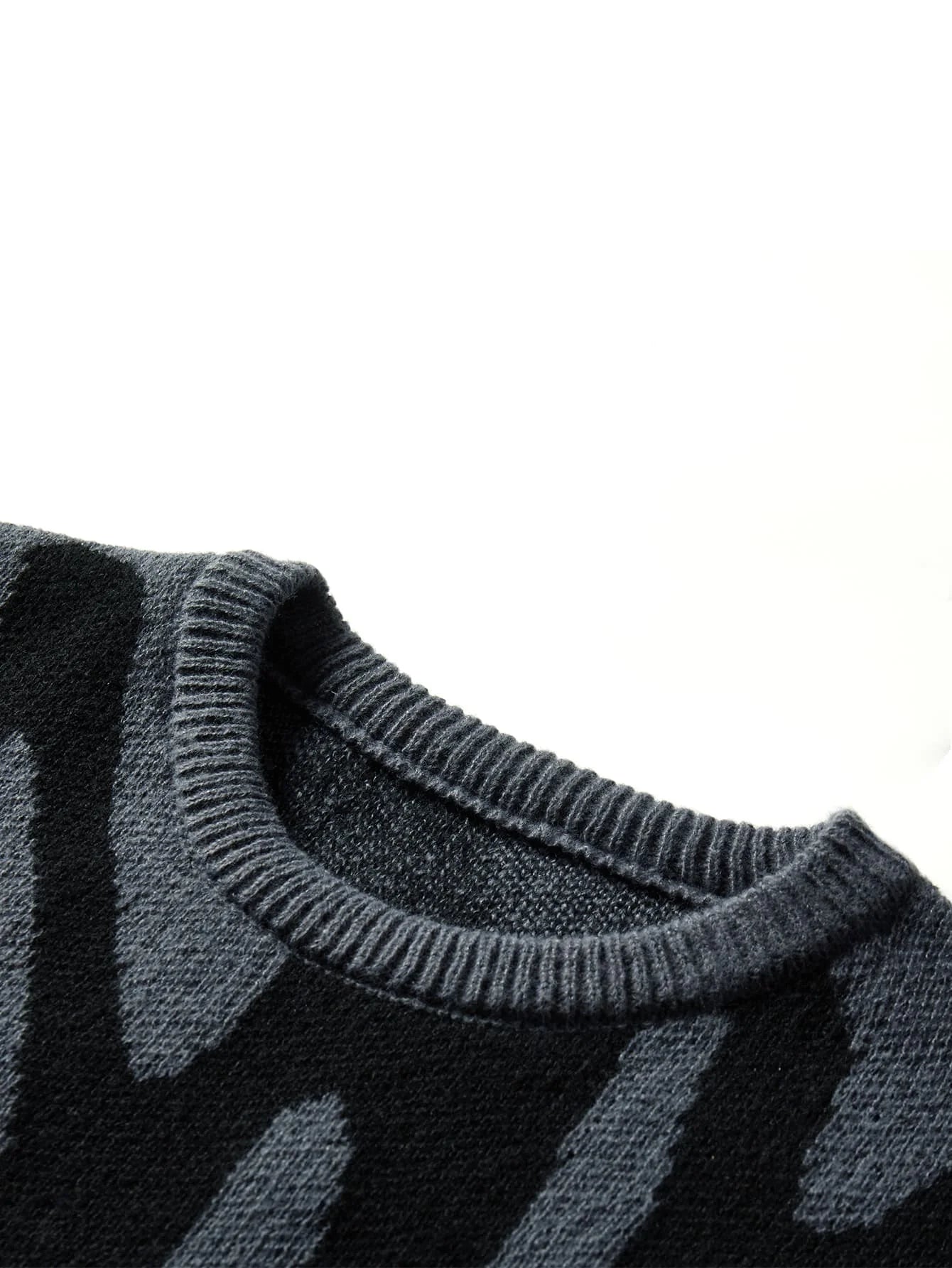 Dark gray wool knit oversized men's sweater with black abstract stripe pattern and ribbed crew neckline, close-up detail view.