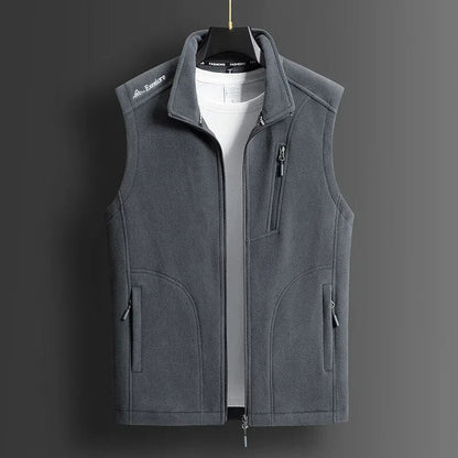 Gray men's fleece zip-up vest with stand collar, chest pocket, and side pockets, displayed on hanger over white tee