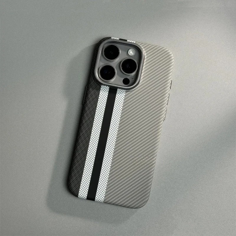 Silver carbon fiber iPhone case with black and white racing stripes and precise triple camera cutout, lying on gray surface.