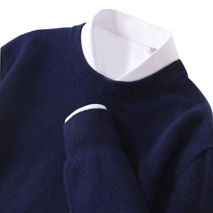 Navy blue cashmere blend men's crewneck sweater with white dress shirt collar layered underneath, chest pocket detail