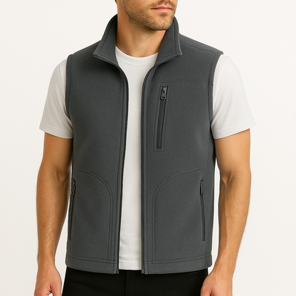 Men's dark gray fleece zip-up vest with mock neck collar and multiple zip pockets, worn open over white t-shirt.