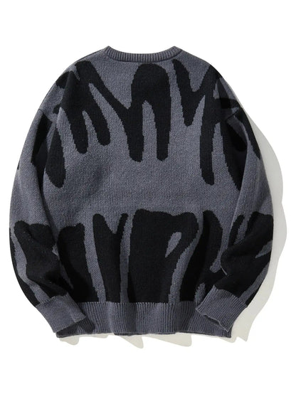 Men's oversized wool knit crewneck sweater in grey with bold black abstract brushstroke pattern, back view.