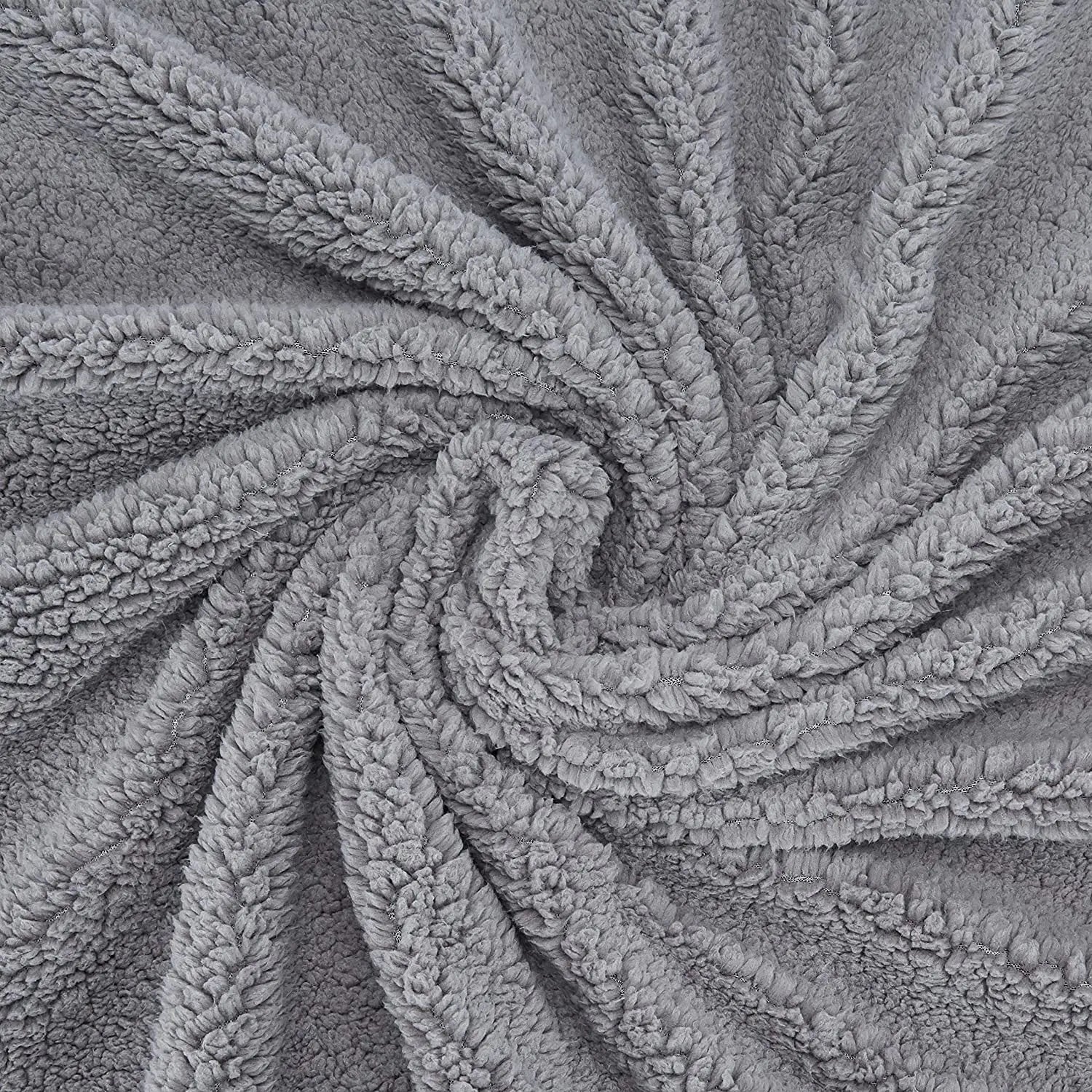 Gray faux fur plush throw blanket with swirling spiral texture pattern and soft fluffy sherpa-like surface