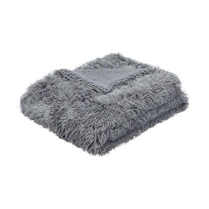 Folded gray faux fur plush throw blanket with long shaggy pile and sherpa reverse side