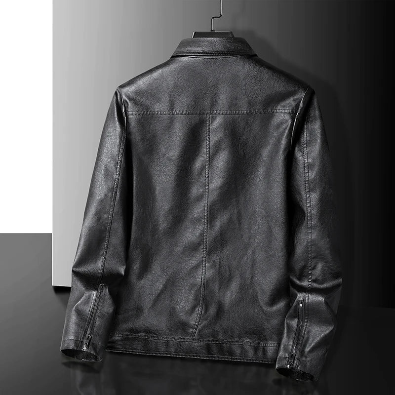 Back view of a black men's leather zip-up jacket with panel stitching and zipper cuffs, displayed on a hanger.