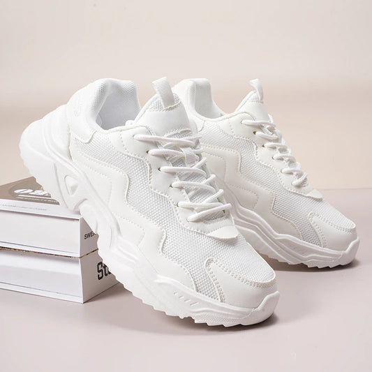 White mesh lace-up chunky sneakers for women with platform sole and textured design on neutral background