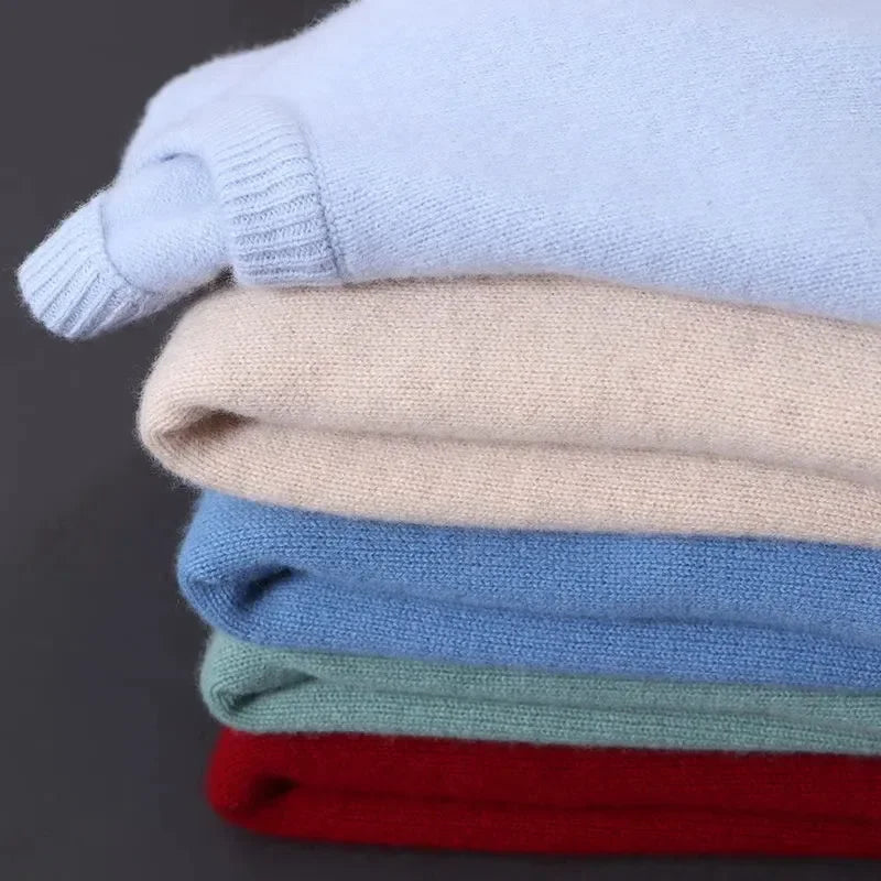 Stack of folded cashmere blend crewneck sweaters for men in light blue, beige, navy, green and red colors