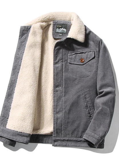 Gray men's corduroy jacket with cream sherpa fleece lining and collar, chest pocket, and brown button detail