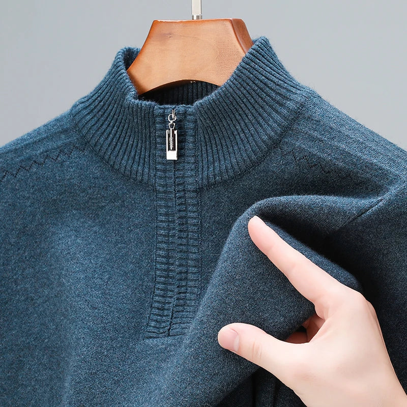 Men's wool blend quarter-zip sweater in teal blue with ribbed collar and zipper detail on wooden hanger