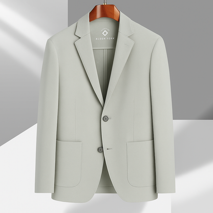 Light sage green Alden York unstructured cotton blazer with notch lapels, patch pockets, and two buttons on wooden hanger.