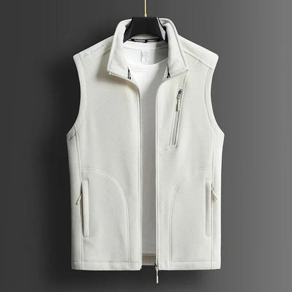 White men's fleece zip-up vest with stand collar, chest zip pocket, and side pockets, displayed on hanger