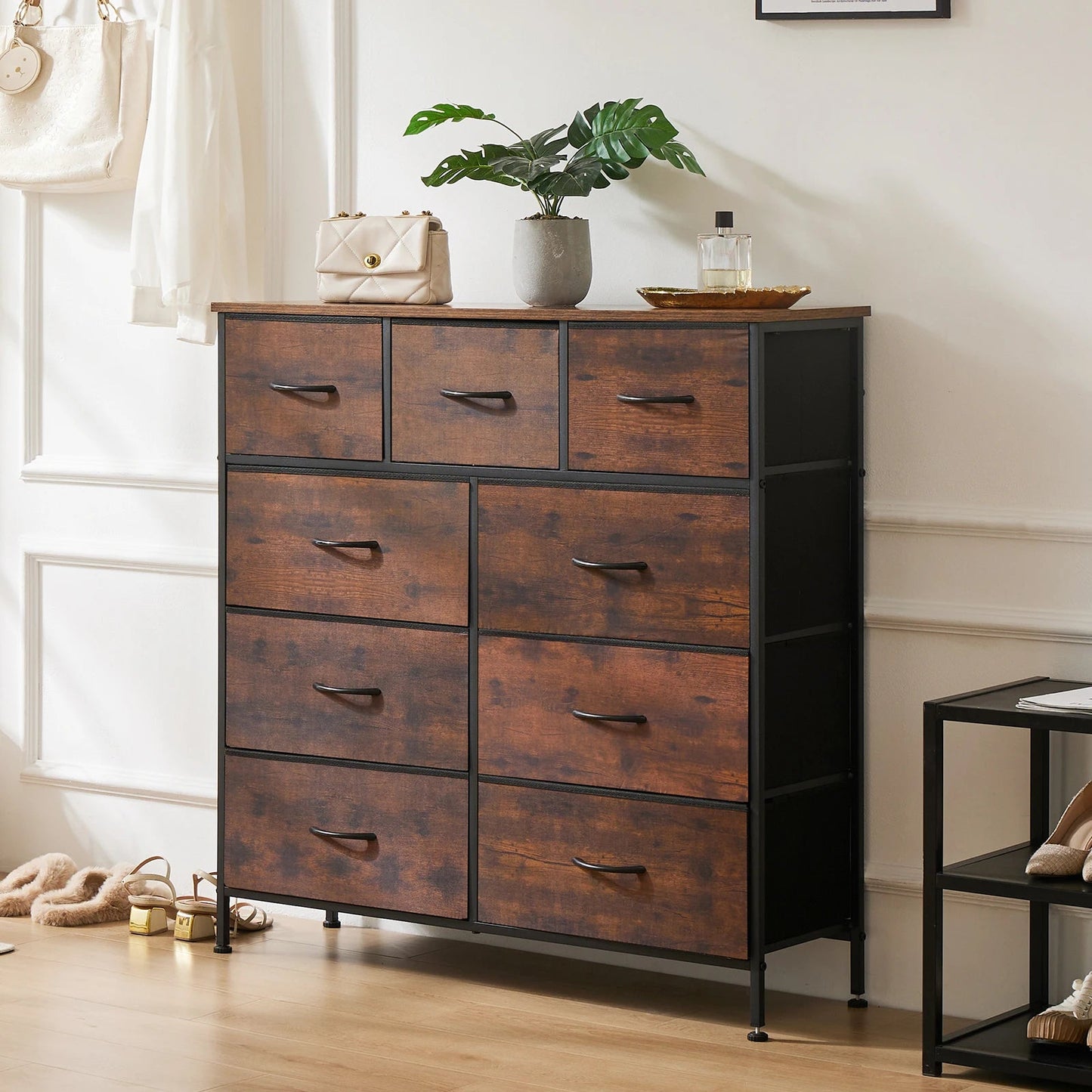 Rustic brown 9-drawer dresser with black metal frame and wood fronts in modern farmhouse bedroom