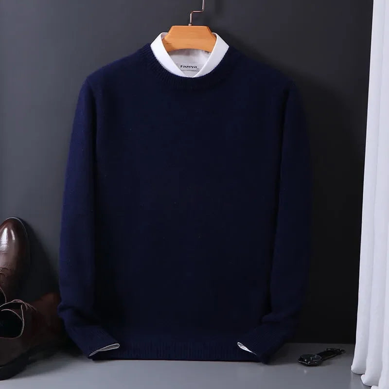Navy blue men's cashmere blend crewneck sweater on hanger, layered over white collared shirt, styled with brown dress shoes.