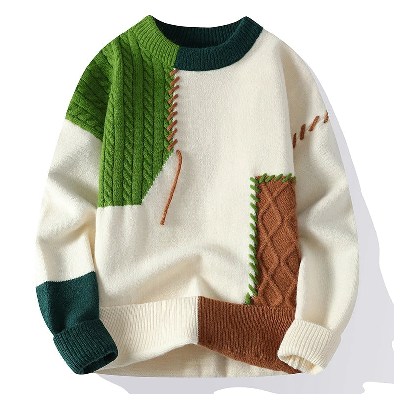 Men's color block cable knit wool sweater in cream, green, and brown patchwork design with crew neck and ribbed cuffs.