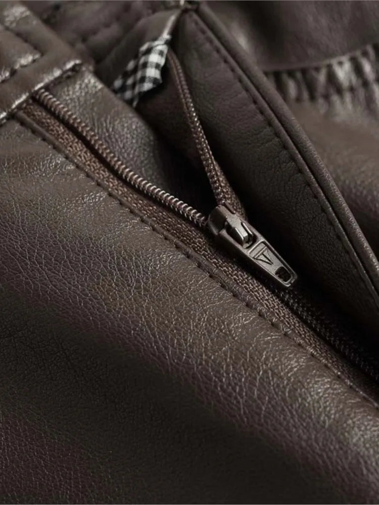 Close-up of dark brown vegan leather high-rise wide-leg pants showing zipper detail and stitching