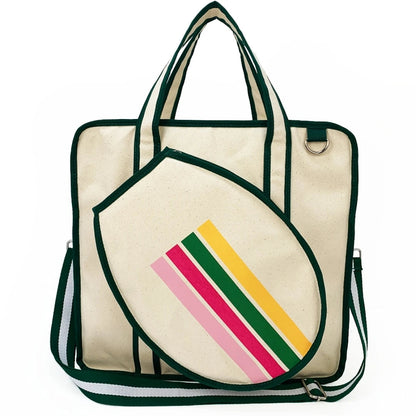 Cream canvas tote bag with green trim, colorful striped front pocket, dual handles and adjustable shoulder strap
