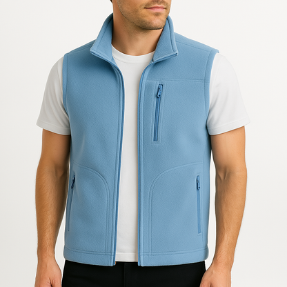 Man wearing a light blue fleece zip-up vest with stand collar and multiple zip pockets over a white t-shirt.