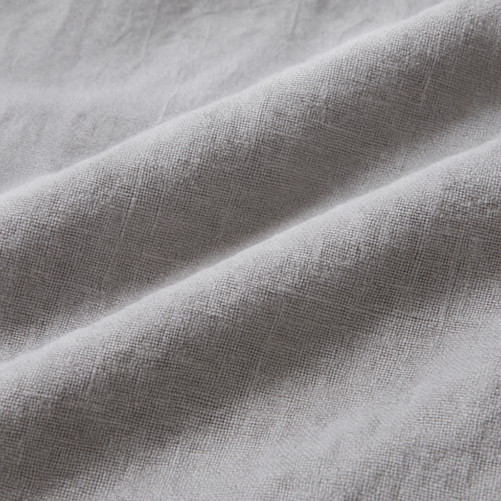 Close-up of soft gray linen fabric with natural texture and gentle folds, used in men's wide-leg drawstring pants.