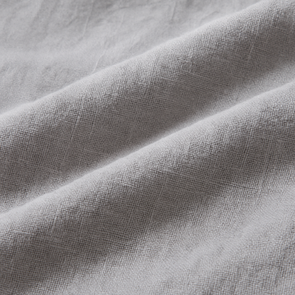 Close-up of soft gray linen fabric with natural texture and gentle folds, used in men's wide-leg drawstring pants.