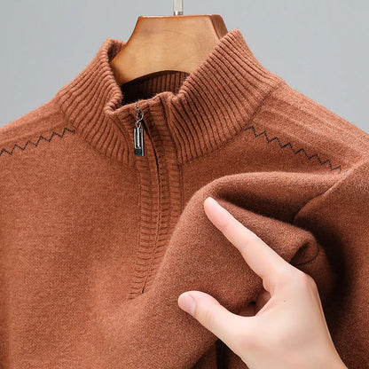 Rust brown men's wool blend quarter-zip sweater with ribbed collar and zigzag pattern, shown on hanger with fabric detail.