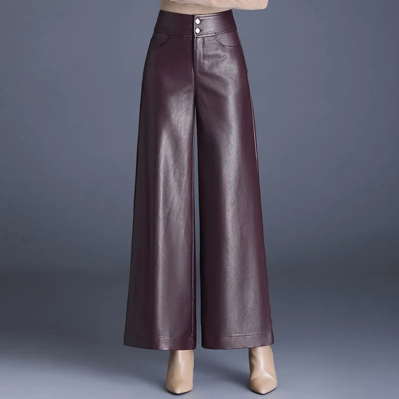 Burgundy high-rise wide-leg vegan leather pants with double button closure, shown with beige heels on gray background.