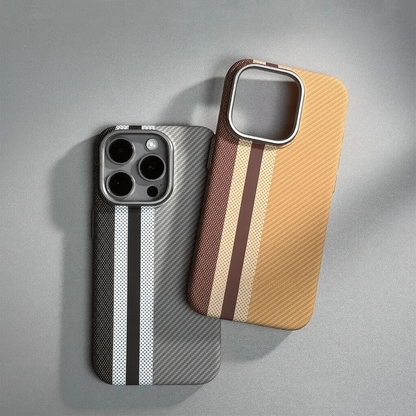 Two striped carbon fiber-textured phone cases in gray-black and tan-brown colorways with camera cutout, displayed on gray surface.