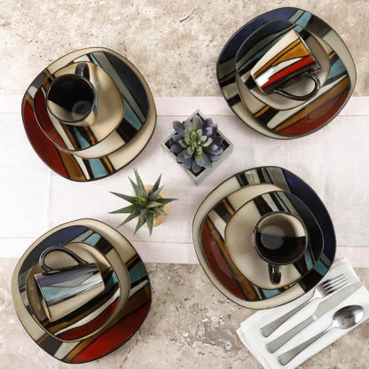 16-piece stoneware dinnerware set for 4 with colorful geometric stripes, including plates, bowls, and mugs, viewed from above.